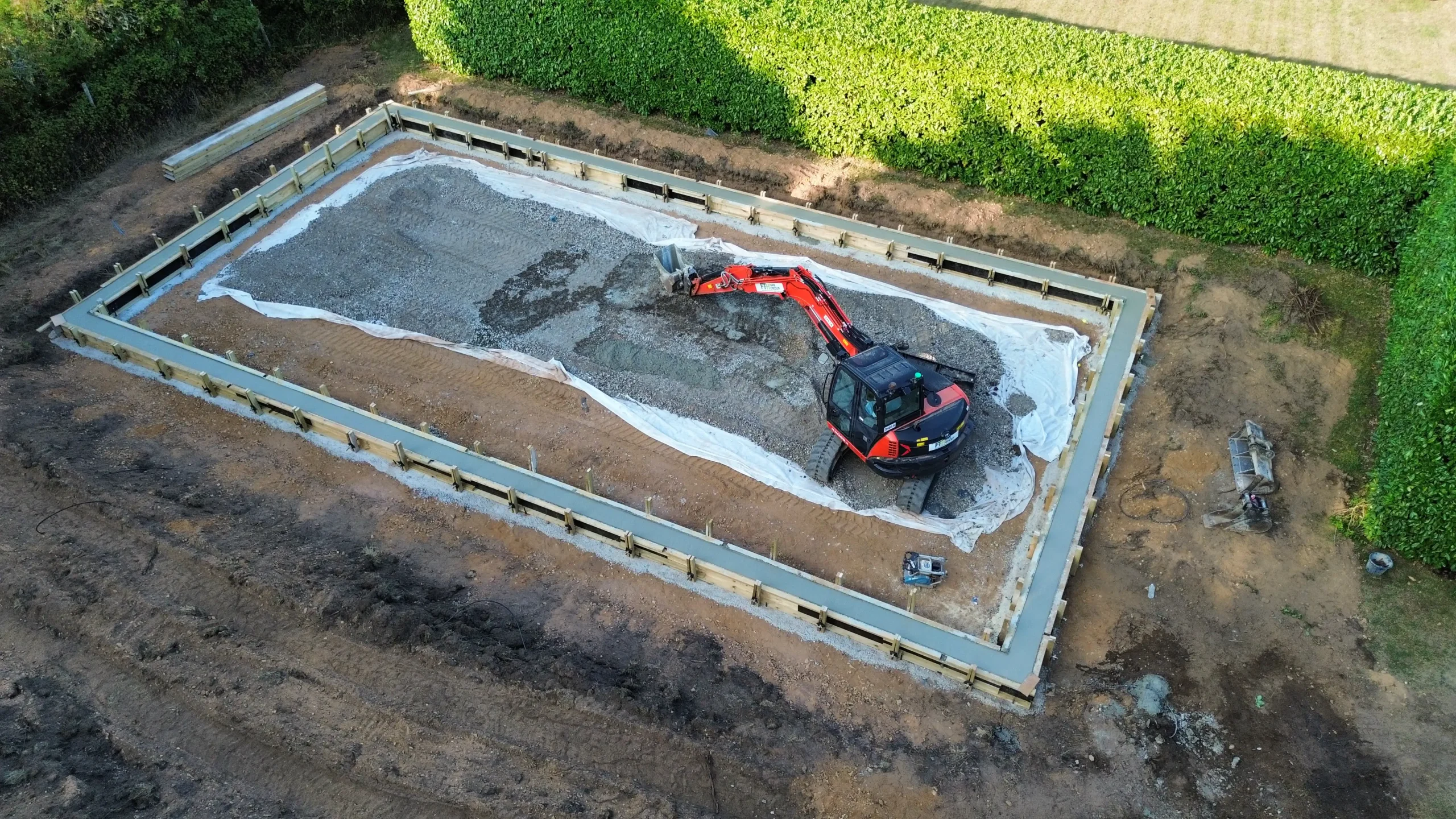 Aerial footage of padel court foundations during slab construction and site preparation